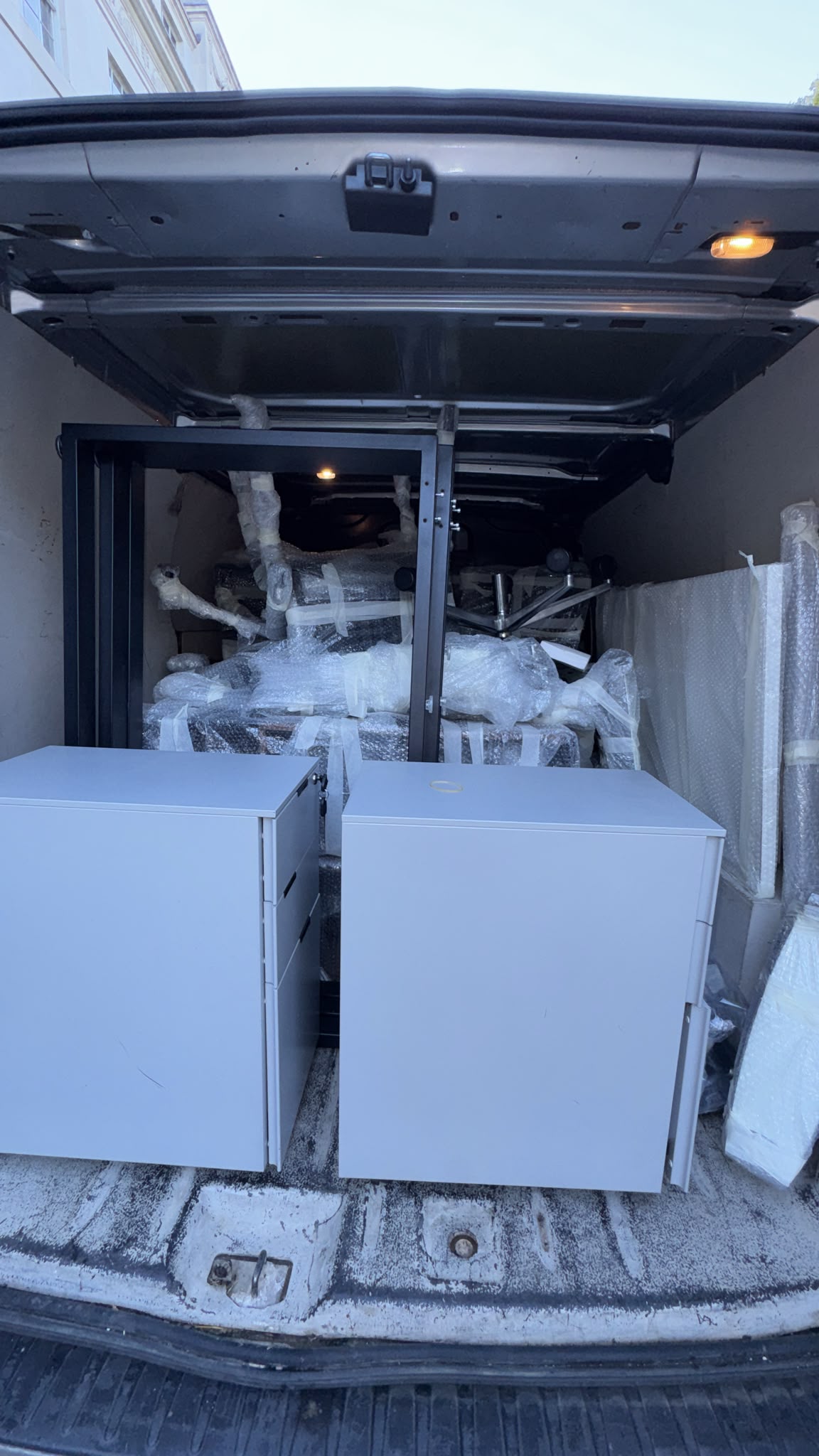 Furniture and wrapped items loaded inside a van
